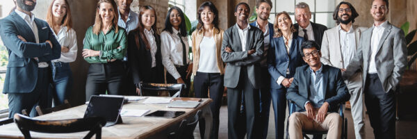 Corporate portrait of a multigenerational working team with multiracial and disabled members - Group photo of colleagues standing in the office in co-working space - business lifestyle concept.